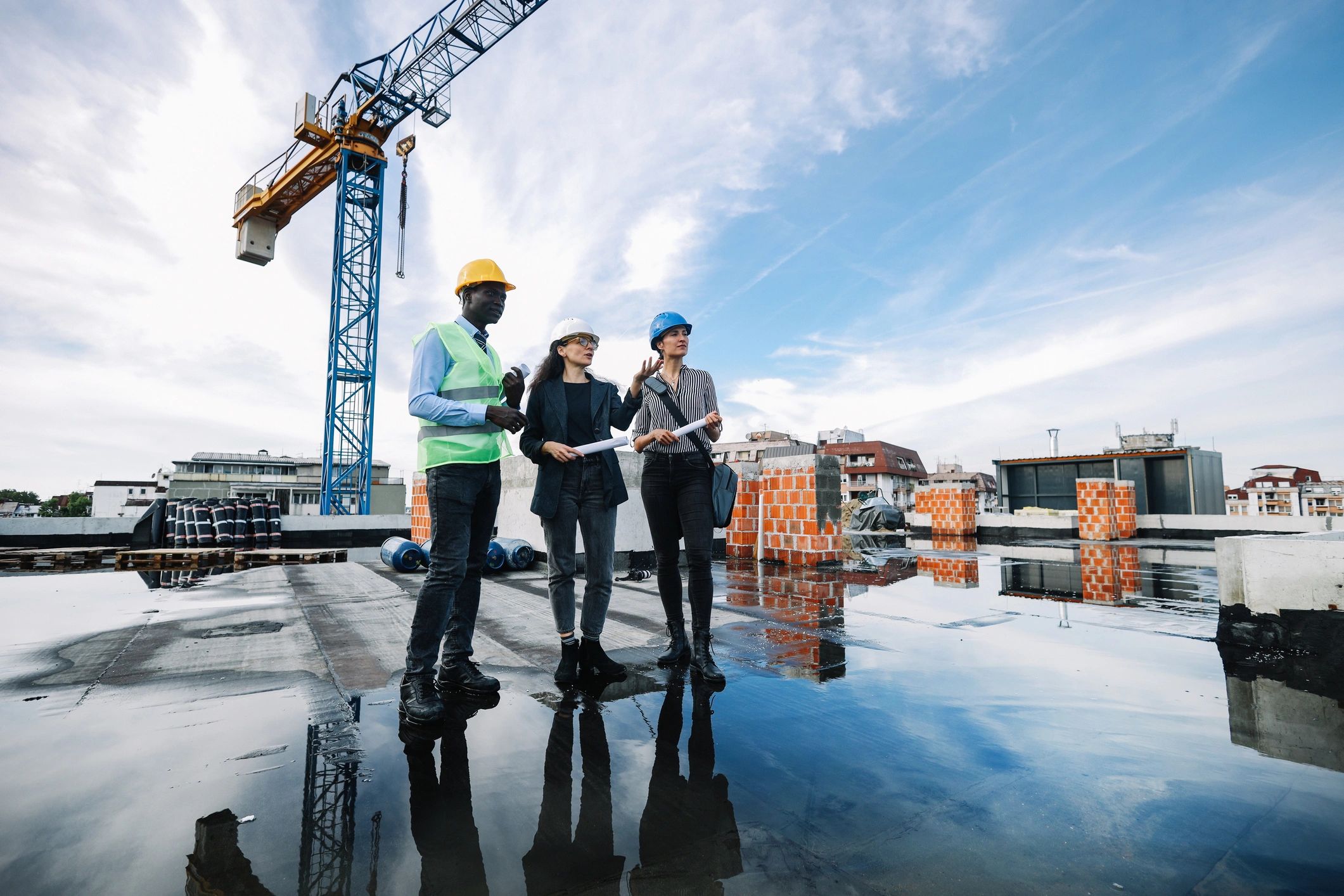 Construction site meeting with workers and plans