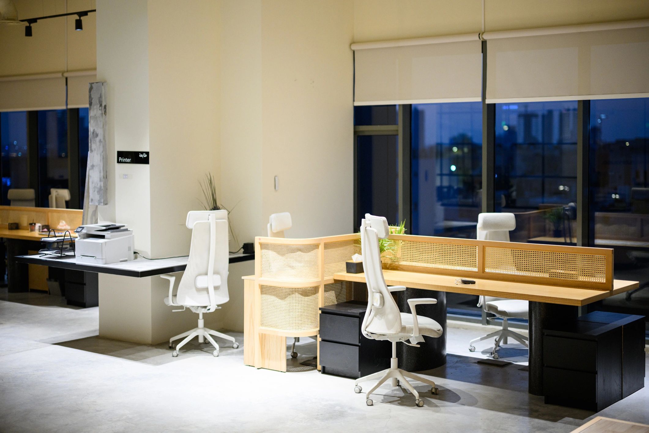 Contemporary office interior with shared desks and large windows
